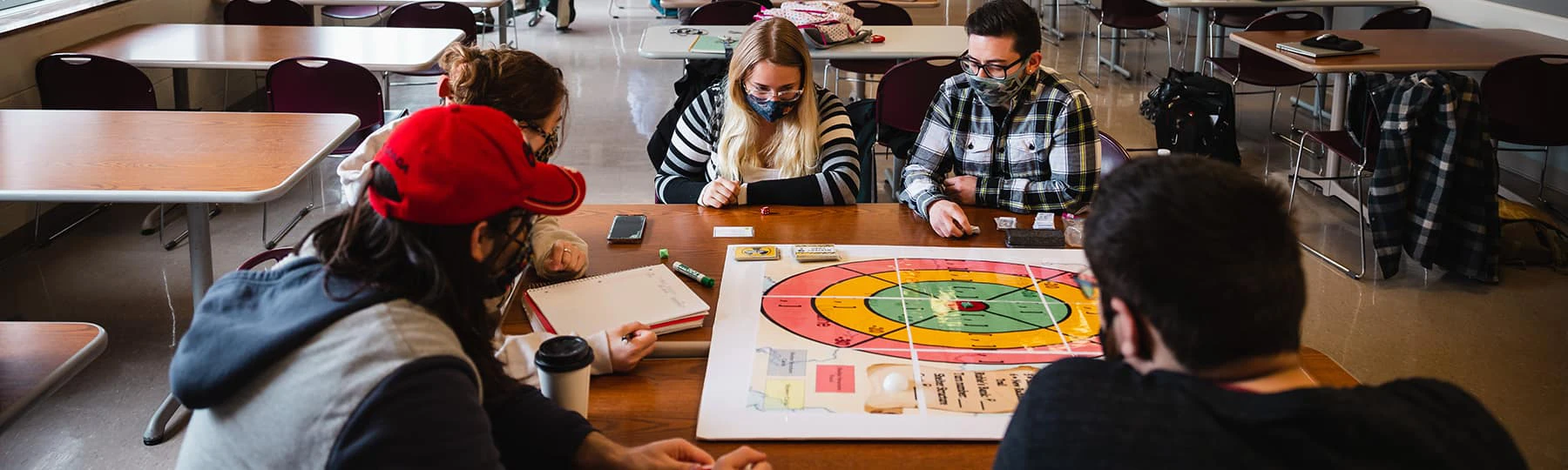 Students in the Game Design Thinking program playing a board game