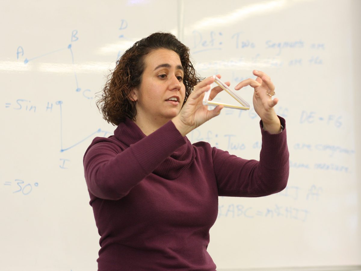 Katrina Piatek-Jimanez explaining formula in front of a class.