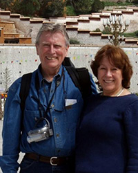 A man and woman standing together outdoors.