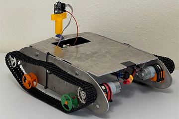 Tracked robotic vehicle with a metal chassis, motorized wheels, and a mounted camera sensor system.