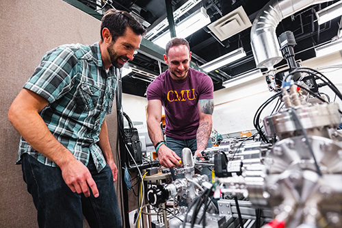 Physics faculty member Matt Redshaw and a student preparing equipment for experimentation