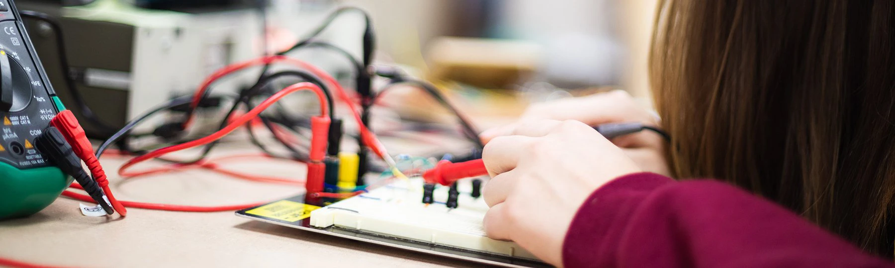 a person using a multimeter to connect wires