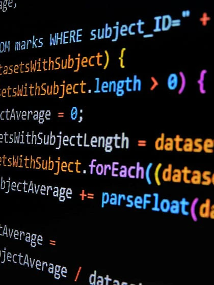 A black computer screen showing database development coding in red, orange, yellow, blue, purple and white.