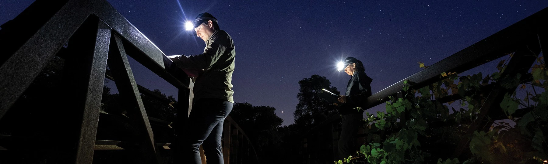 a couple of men with headphones and a flashlight