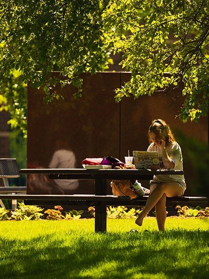 a woman sitting on a picnic table