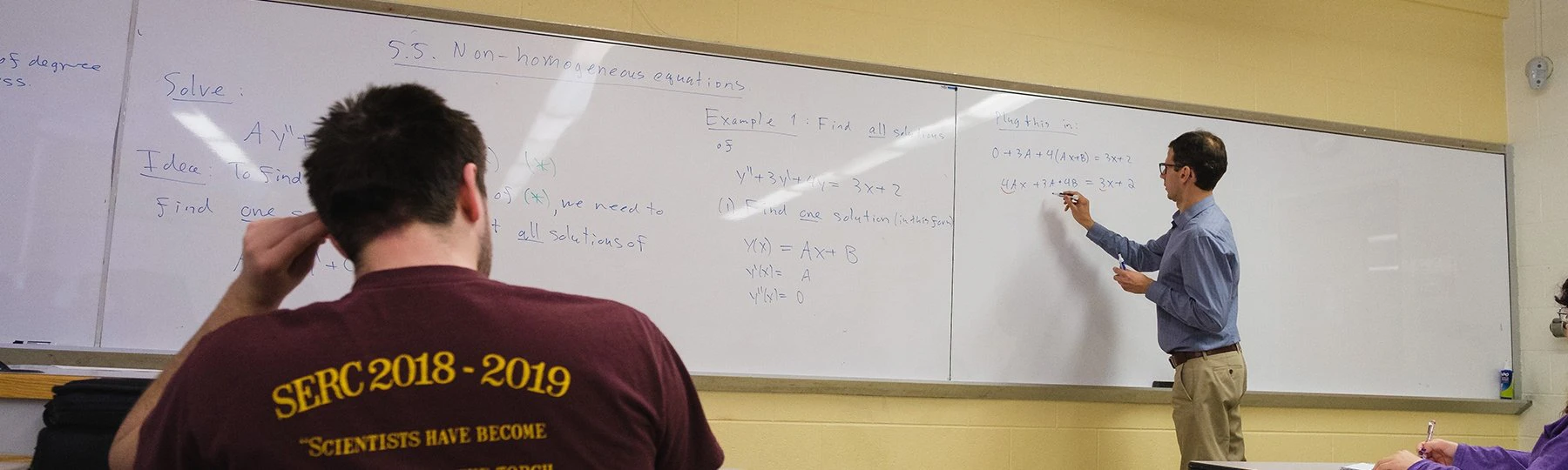 a person standing in front of a whiteboard