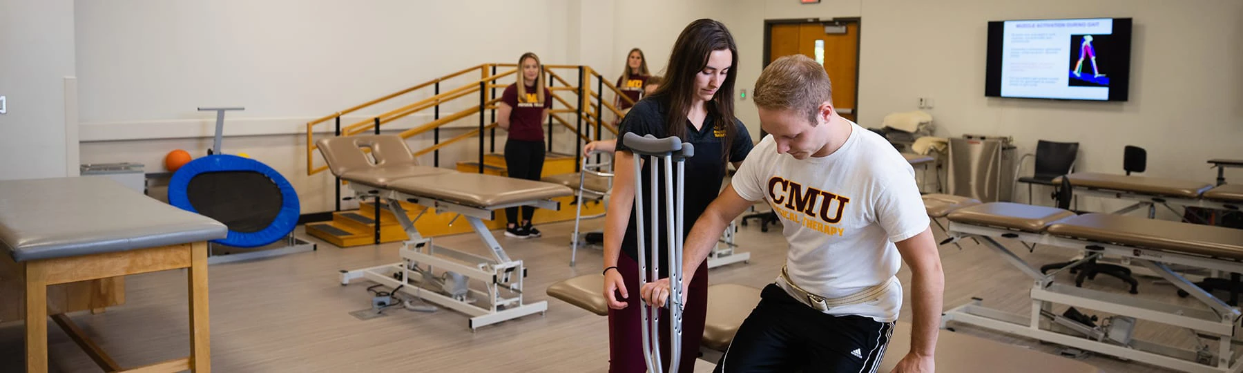 A pre-occupational therapy student works with a patient with crutches.