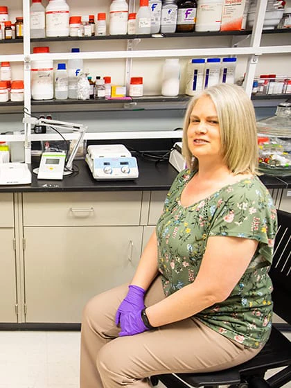 A pre-pharmacy student talks with a professor in an on-campus lab.