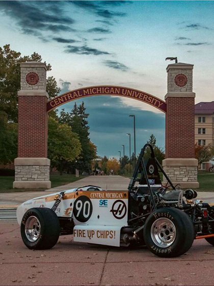 Formula SAE car parked in front of the CMU arch.