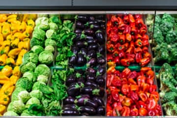 A colorful display of rows of vegetables in a store.