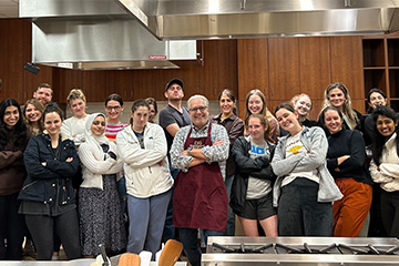 Students pose with Dr. Jeff Fisher in the test kitchen on campus.