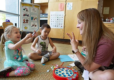 Communication Sciences and Disorders students sign language with children