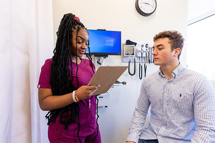 Nursing student reviewing a patient's chart