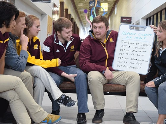 Students sitting discussing an event