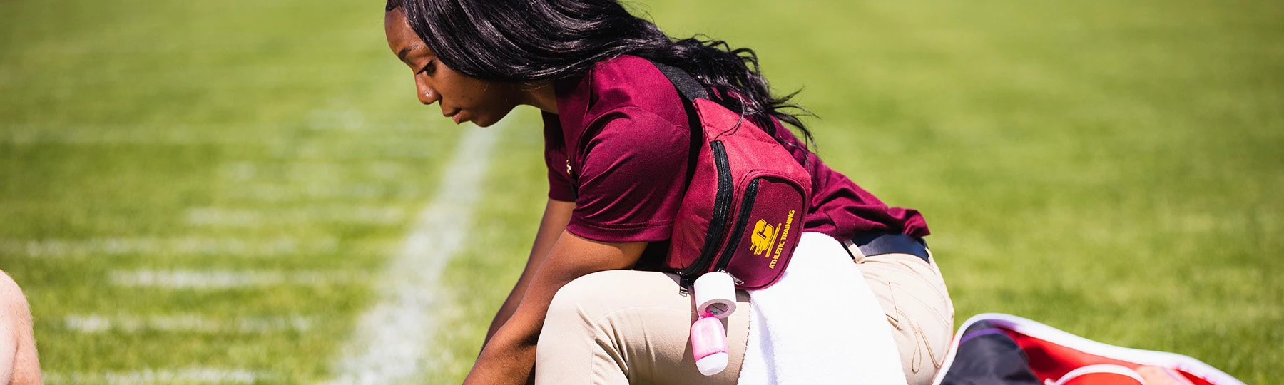 athletic trainer on football field