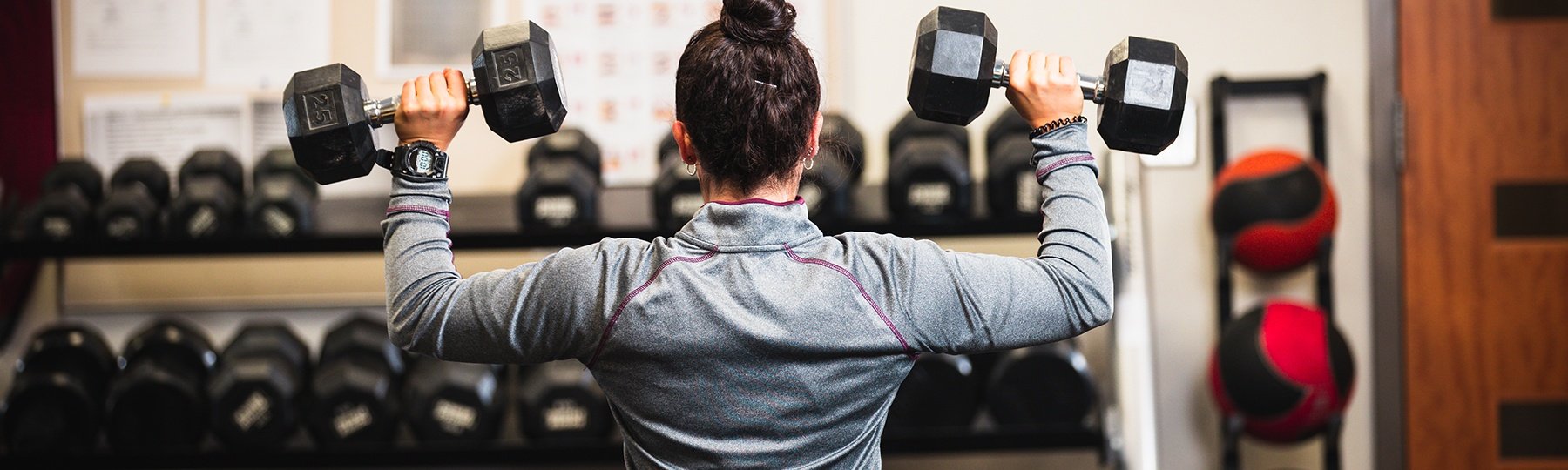 student with fitness weights