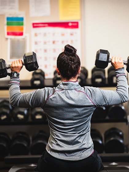 student with fitness weights