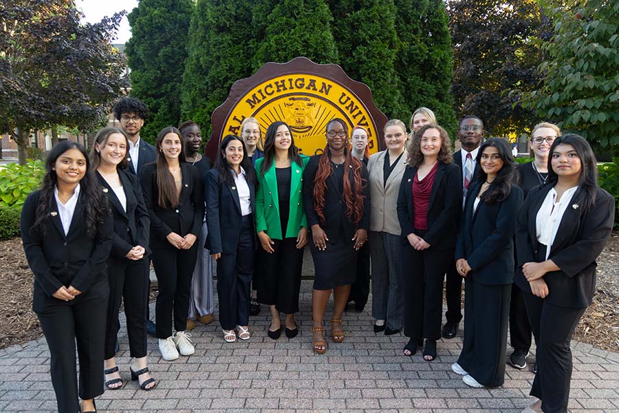 Student Government Association group photo by the Central Michigan University Seal on Warriner Mall in front of Warriner Hall.