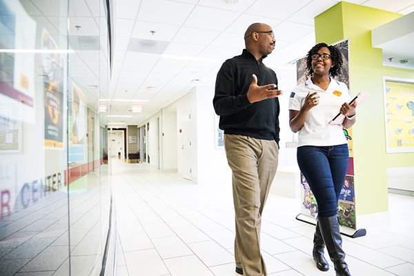 People walking inside campus building