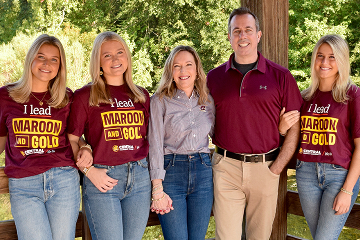 President-Elect Neil MacKinnon poses with his wife Leanne and their three daughters wearing Central Michigan University shirts.