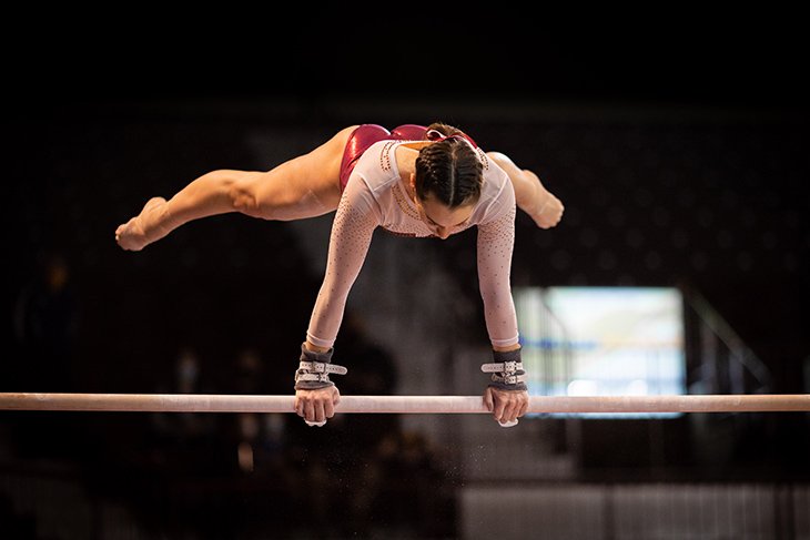 A member of the CMU Gymnastics team performs their routine on the uneven bars.