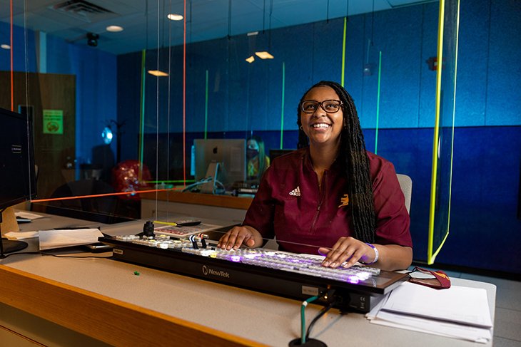 Gena Harris poses in the television control room, where she works as a producer and anchor for News Central.