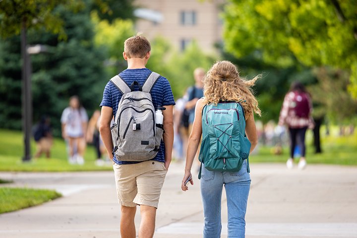 Students walk to classes on a warm, summer morning.