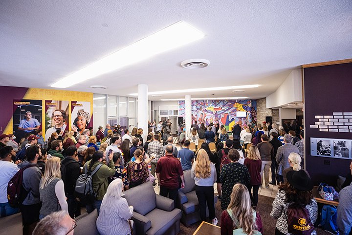 Members of the Central Michigan University Community gather in the Bovee University Center for the dedication of the Native American mural.