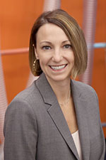 Jennifer Cotter, Interim Vice President for Advancement, wears a grey blazer and smiles for a headshot.