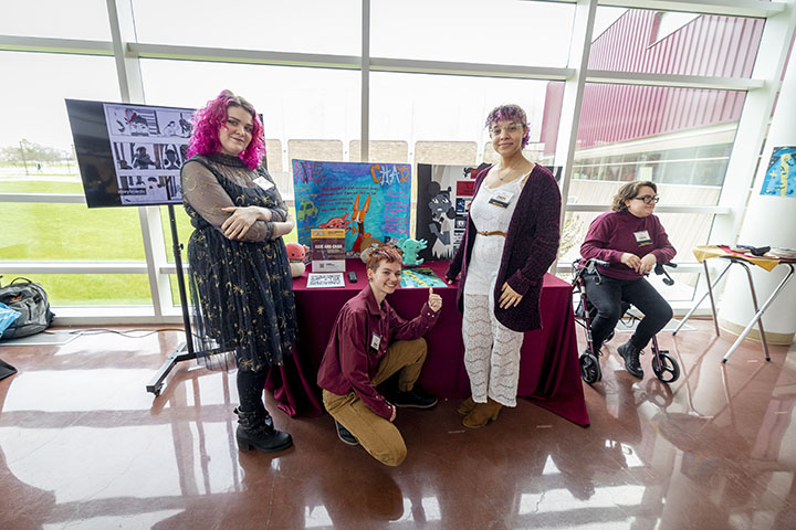 Students in CMU's animation program stand in front of a display of their project at the New Venture Challenge's Campus Innovation Showcase.