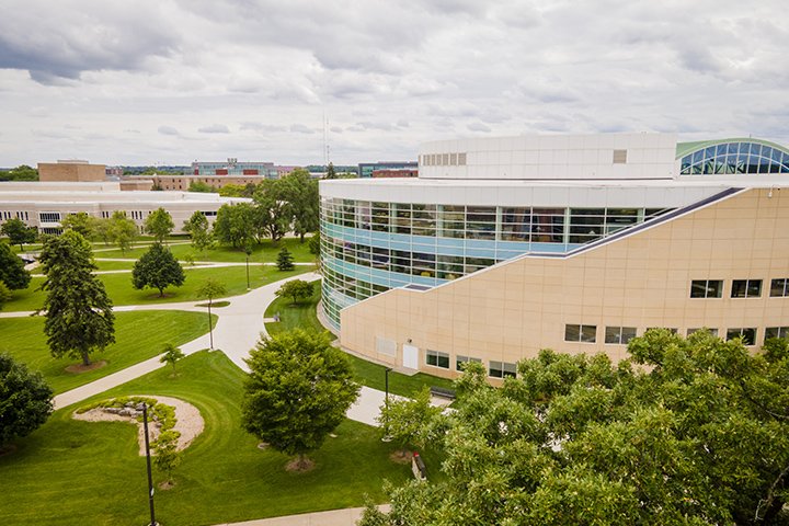 An aerial view of the Charles V. Park Library with overcast skies and green trees and grass surrounding the building.