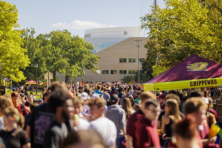 Thousands of college students gather outside near Finch Fieldhouse and the Park Library as part of the MainStage event.