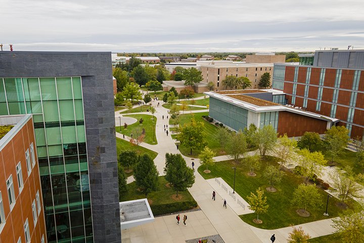 An aerial view of CMU's campus as students walk to class down pathways in the middle of campus.