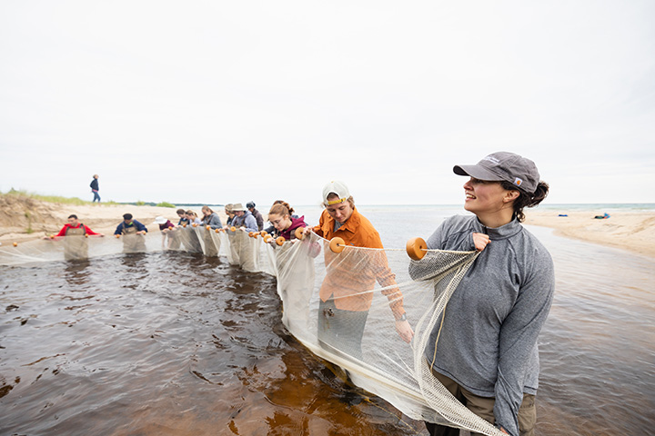 CMU students set up nets in the mouth of the Jordan River on Beaver Island.