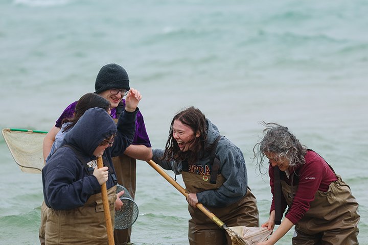 Students and faculty members get caught in a storm while netting for fish.