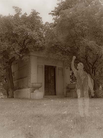 A shadowy figure stands in front of a mausoleum in a vintage styled picture.