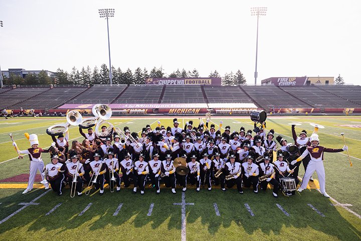 Members of the CMU marching band pose for a group photo on the Kelly/Shorts turf.