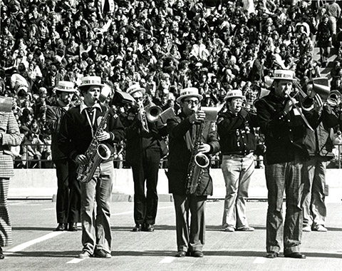 An undated black and white photo shows Alumni members of CMU’s Marching Chippewas performing a halftime show during homecoming festivities.