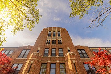 Central Michigan University's towering brick administration building bathed in morning light.