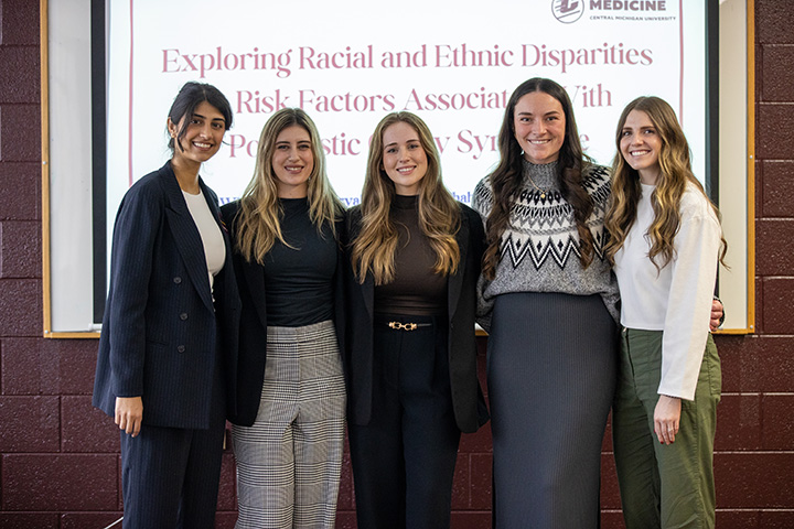 Five female students pose for a group photo.