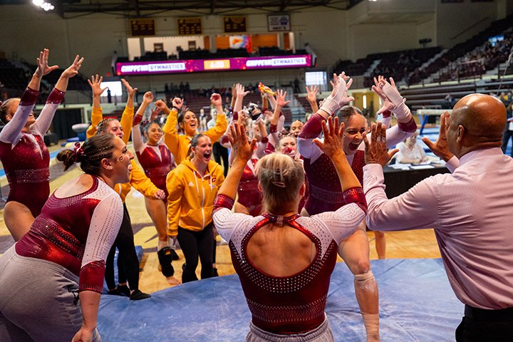 The CMU gymnastics team huddles up and celebrates winning the MAC championship.