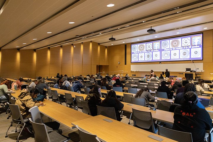 Inside a large lecture hall, Nepalese students get together.
