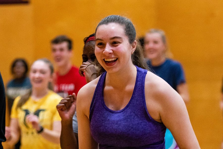 A large group of students participating in a Zumba activity in the Recreation Center.