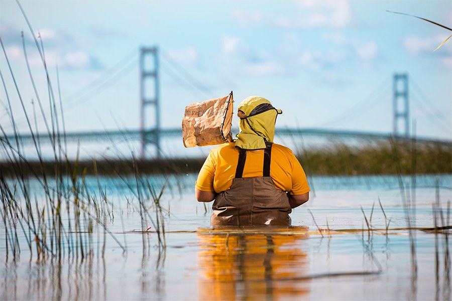 research student in water at Mackinaw Bridge