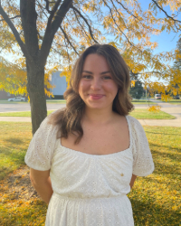 Olivia Headshot of Olivia in a white dress