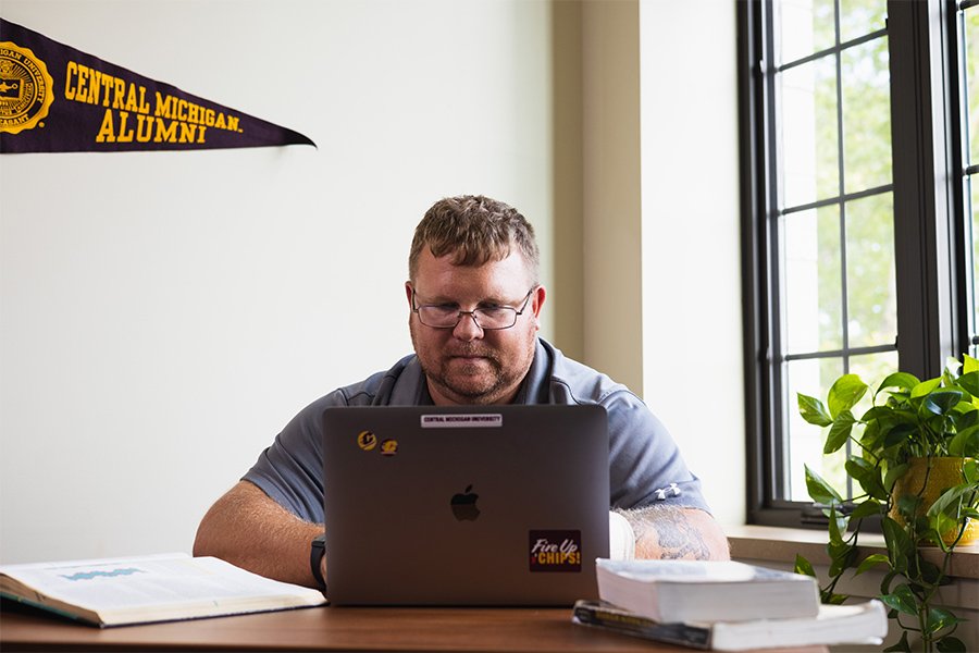 student at desk with laptop