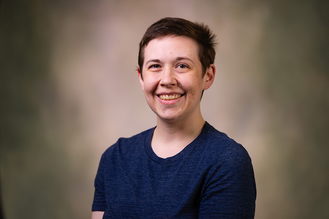 Professional headshot of Hannah Amerson wearing a dark blue shirt while looking at the camera.