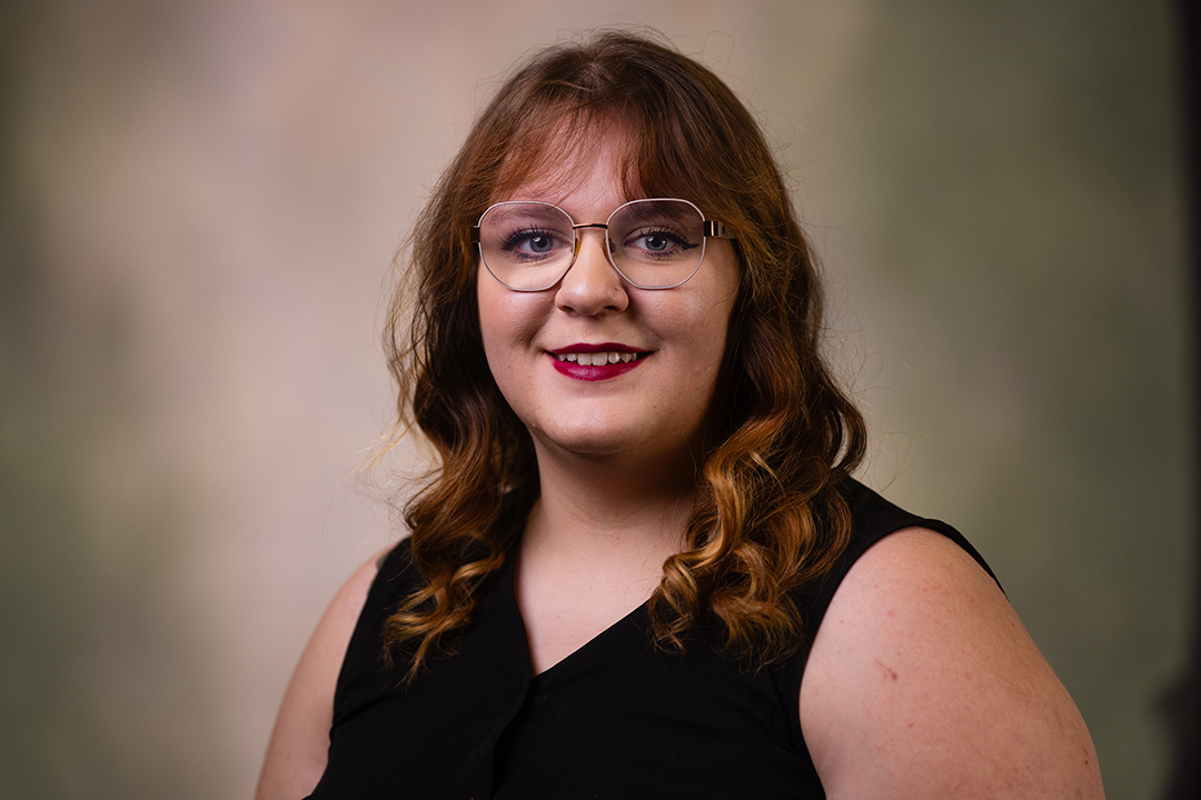 Professional headshot of Veronica McCreary wearing a black sweater vest while looking at the camera.