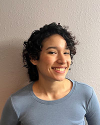 Mark Rodriguez smiling for a professional headshot while standing against a white background.