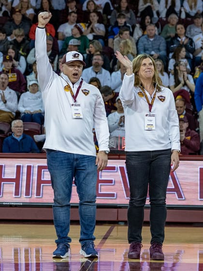 Tim and Sherry Magnusson being honored on court at CMU basketball game.